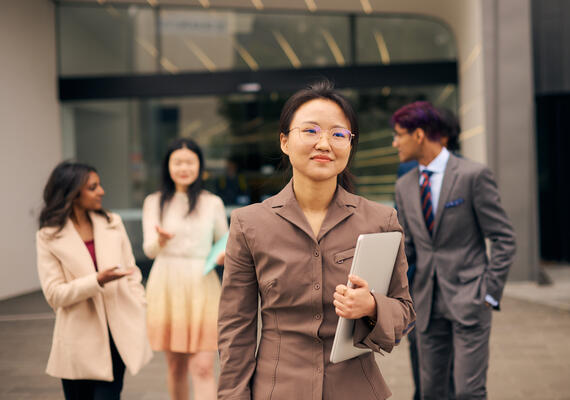 Deakin faculty of business and law student researchers socialising on campus.