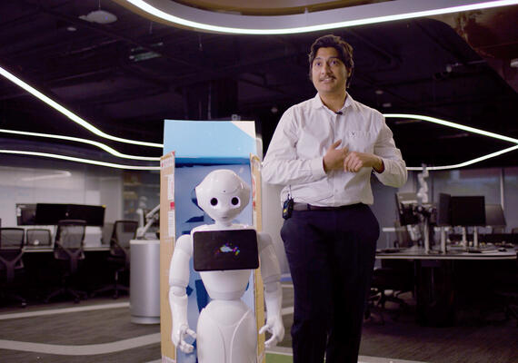 Yash is standing beside a short robot