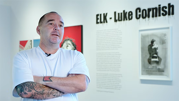 ELK - Luke Cornish stands in front of his artwork.