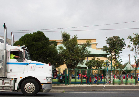 Truck driving past school playground