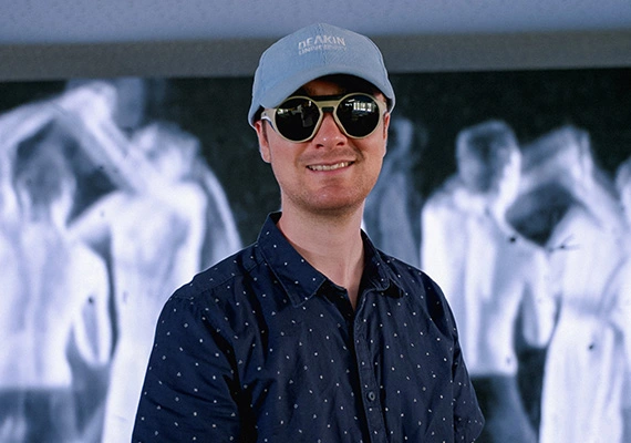 Tim Harte against a backdrop of ballet dancers