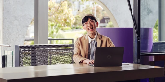 An undergraduate student studying with a laptop at a cafe on the Waurn Ponds campus.