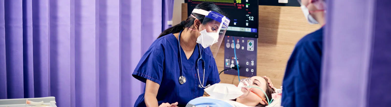 A Deakin postgraduate nursing student attends to a patient. 
