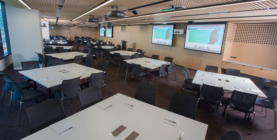 Large room set up with multiple tables group together at Melbourne Downtown Corporate Centre.