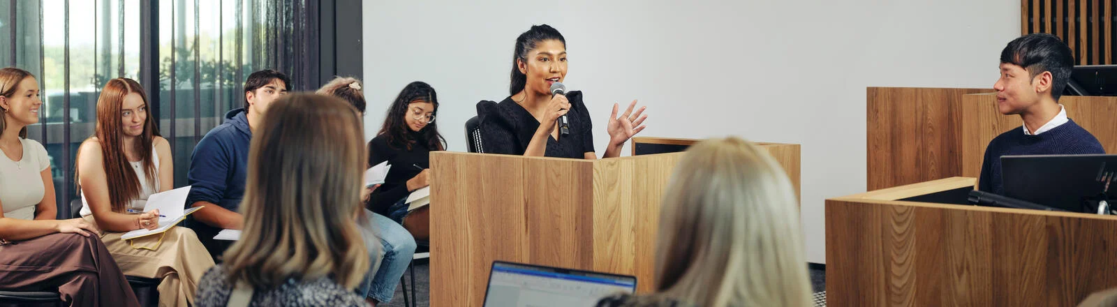 Deakin student presents to group of people.