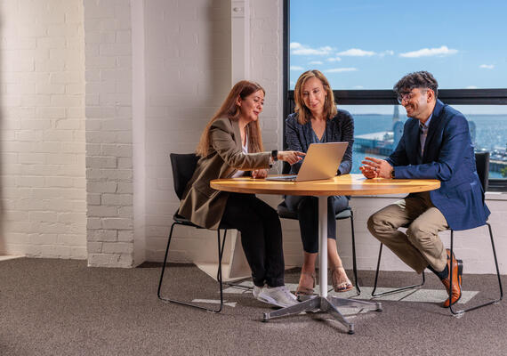 Three architecture academics sitting at a table. 