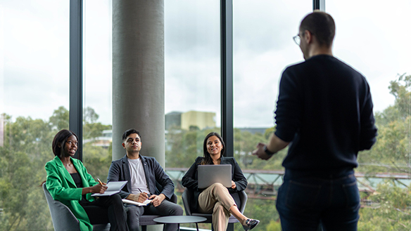 Deakin business students talk with one of the course directors.