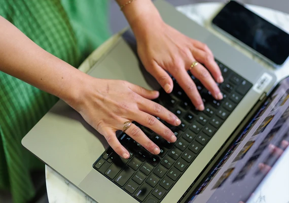 A person typing on a laptop.