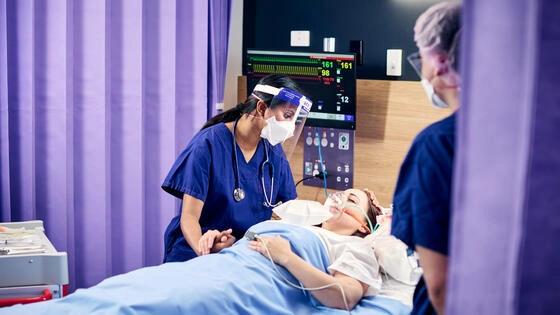 A Deakin postgraduate nursing student attends to a patient. 