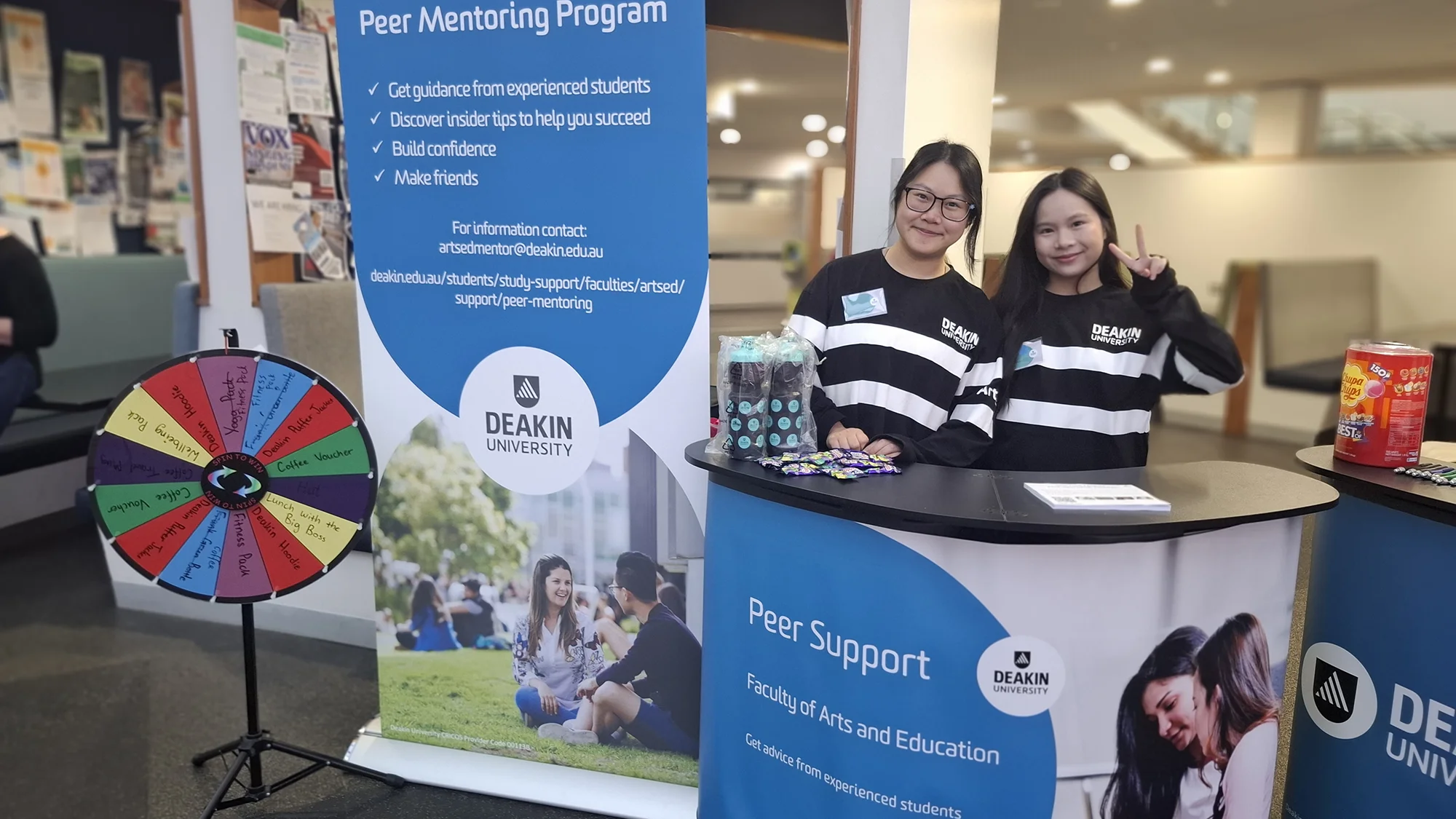 Joycely at a desk with peer mentor advertising