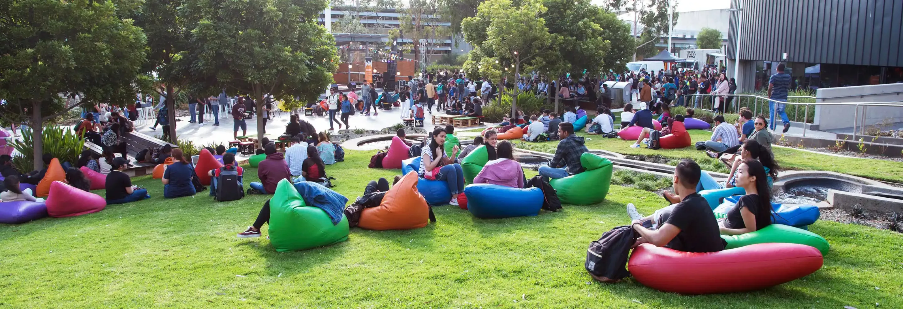 Student relaxing on the lawn at Burwood Campus