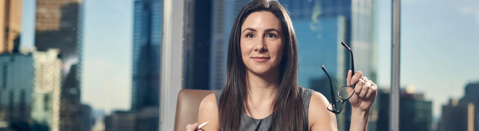 A Deakin postgraduate leadership student sits at a desk.