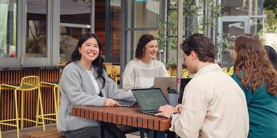 A group of Deakin students study at the Burwood campus cafe