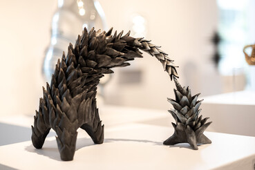 Deakin University Contemporary Small Sculpture Award 2025 - Highly Commended recipient (Supported by UniSuper). Ceramic sculpture in dark hues consisting of two parts 'reaching' for each other (both with multiple 'fronds' resembling an abstract form from the natural world).