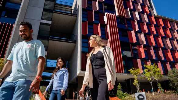 Students walking past deakin's on campus accomodation