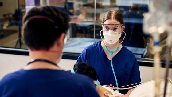 Two postgraduate Deakin nursing students in PPE.