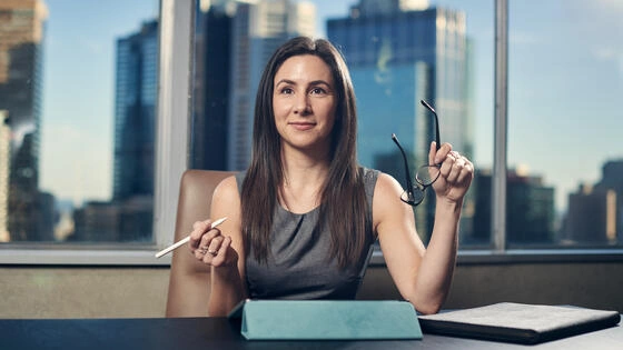 A Deakin postgraduate leadership student sits at a desk.