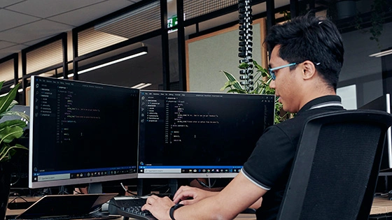 A Deakin IT student works on a computer.