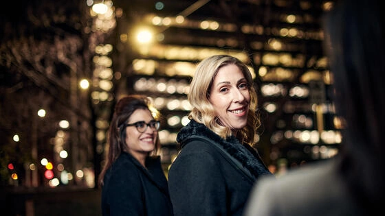 Two Deakin Graduate Certificate of Business students in the city at night. 