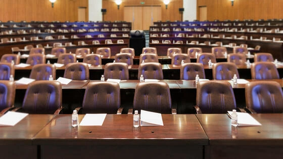 Interior of a modern conference hall for business meeting or parliamentary discussions.