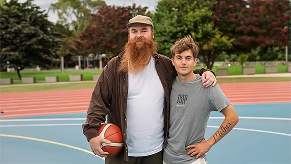 Ramas on a basketball court with a player.
