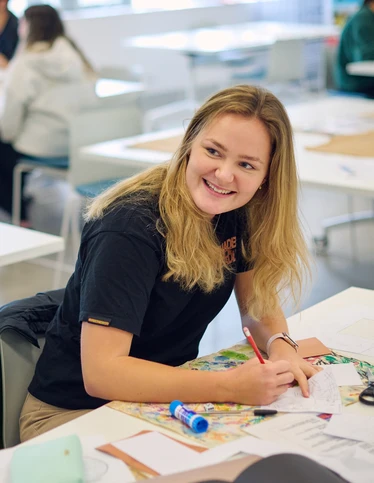A bachelor of primary education student at placement in the classroom.