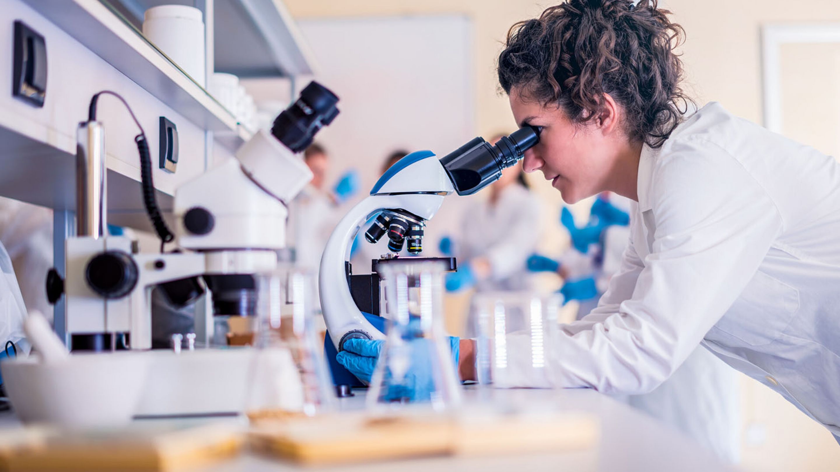 Student using a microscope in a lab