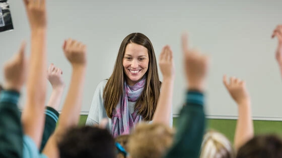 Deakin Master of Education student in a classroom of students. 