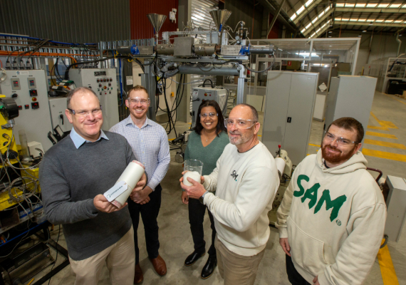 A group of researchers working on synthetic fabric recycling technology.