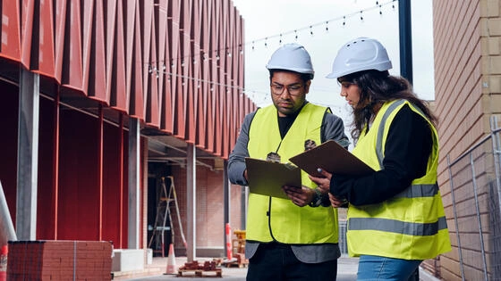 Two Deakin postgraduate construction management students on a construction site. 